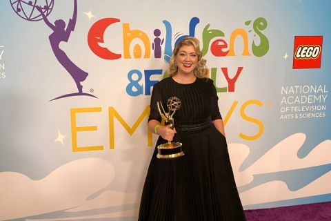 Woman in black dress at awards show